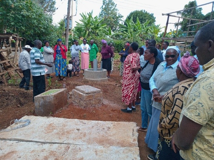 Farmer sharing benefit of renewable energy during a Board members monitoring activity in Oloitoktok project area.