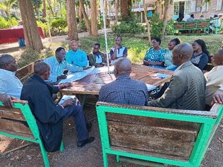 Farmers in a meeting discussing policies.