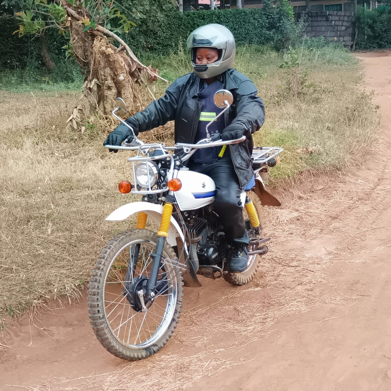 Jeniffer Wairimu a SACDEP Field officer on a motorcycle in the field
