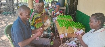 Members of Garithe Youth Group taking part in coconut oil packaging.